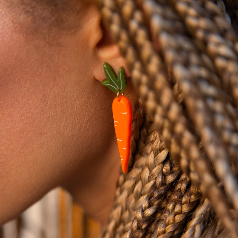 carrot earrings on model by woll