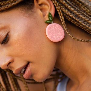 Large Acrylic Grapefruit Earrings on a model by WOLL