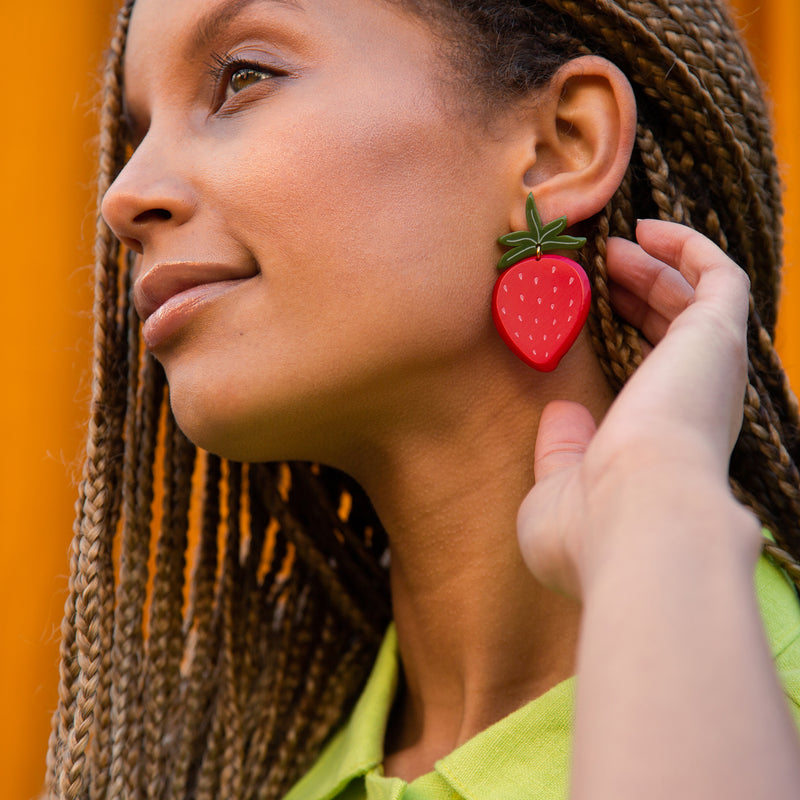 large strawberry earrings on model